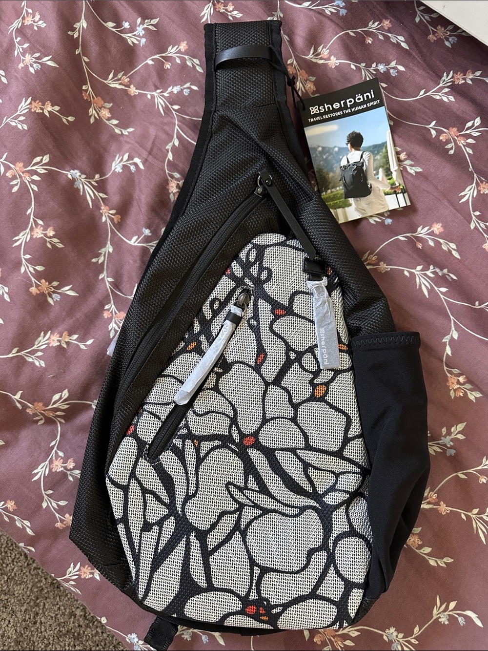 Sherpani Black & White Floral Sling Backpack with Subtle Red Accents